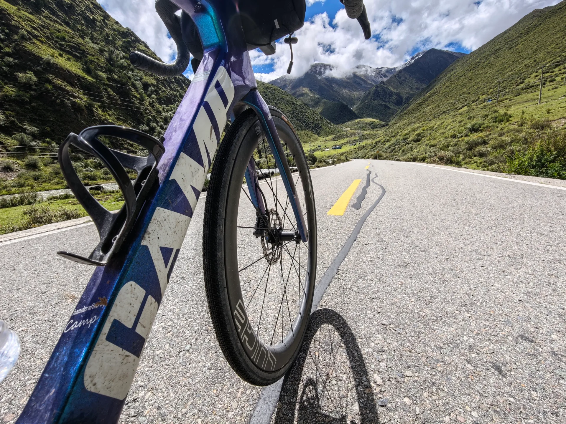 Mountain road beneath a bright blue sky