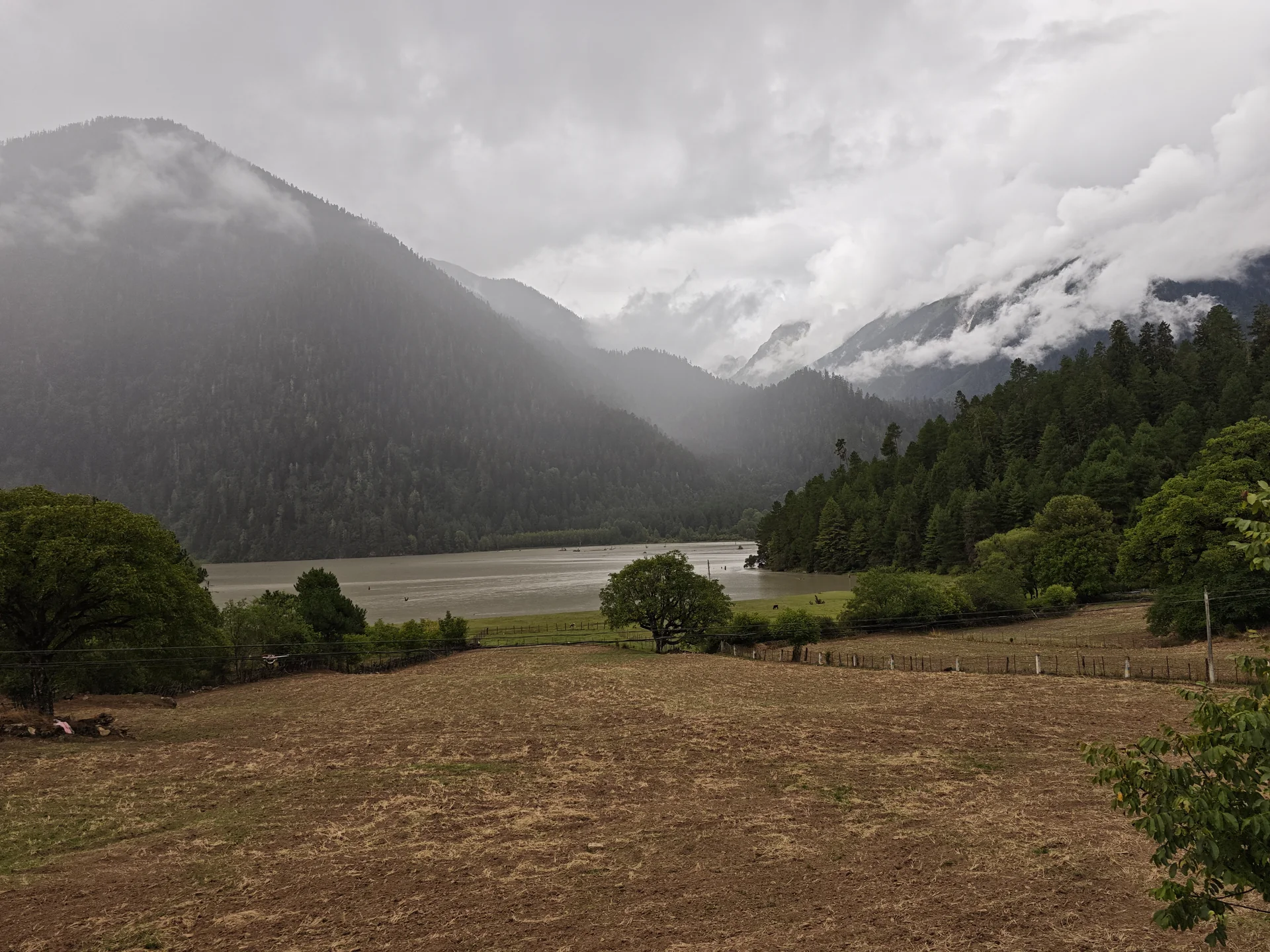 Mist drifting over a lake and surrounding highlands