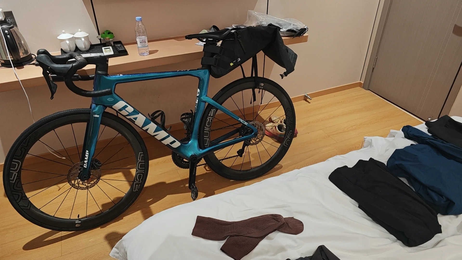 A touring bicycle packed for the trip in a hotel room