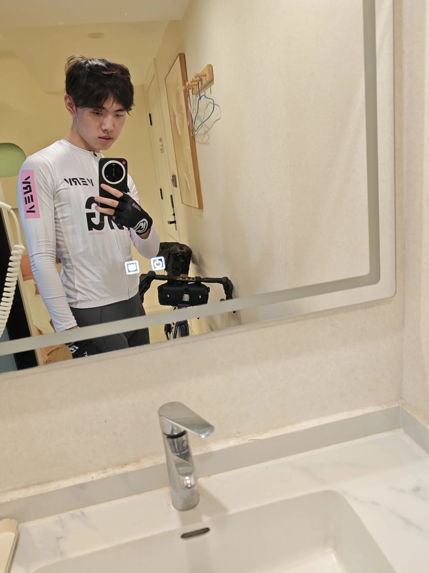 A cyclist taking a mirror selfie before the ride