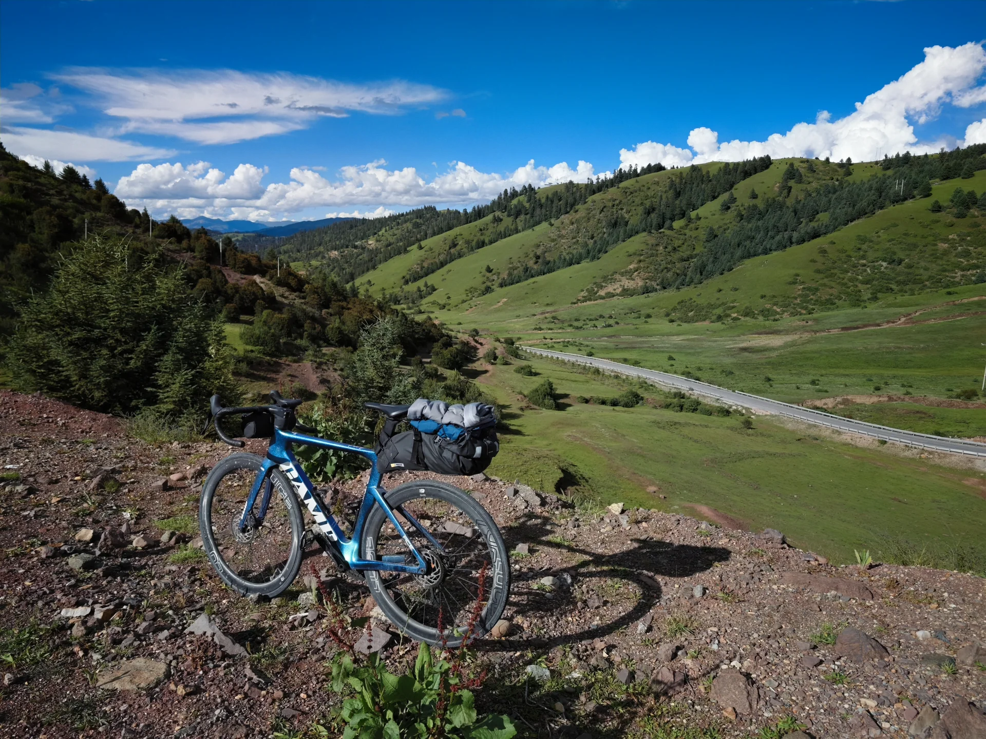 A bicycle resting beside a trail in the highlands