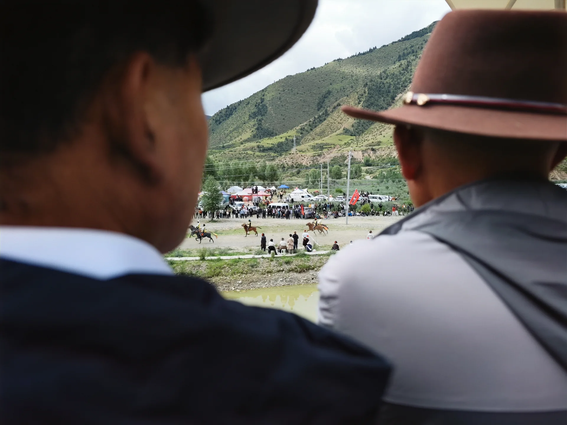 Spectators watching an event across a grassy field