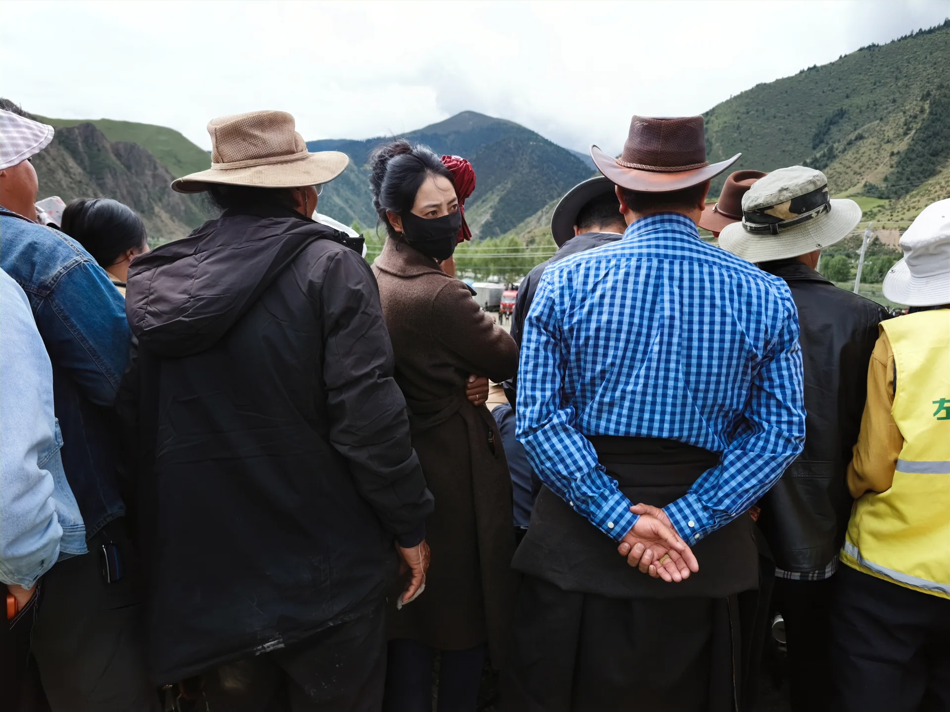 A crowd watching an outdoor event in the highlands