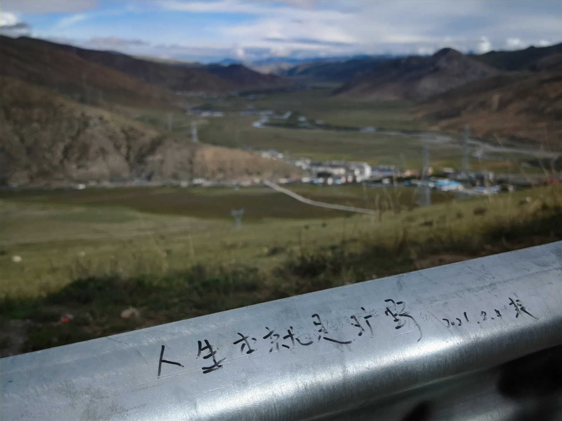 A winding road crossing a broad mountain valley
