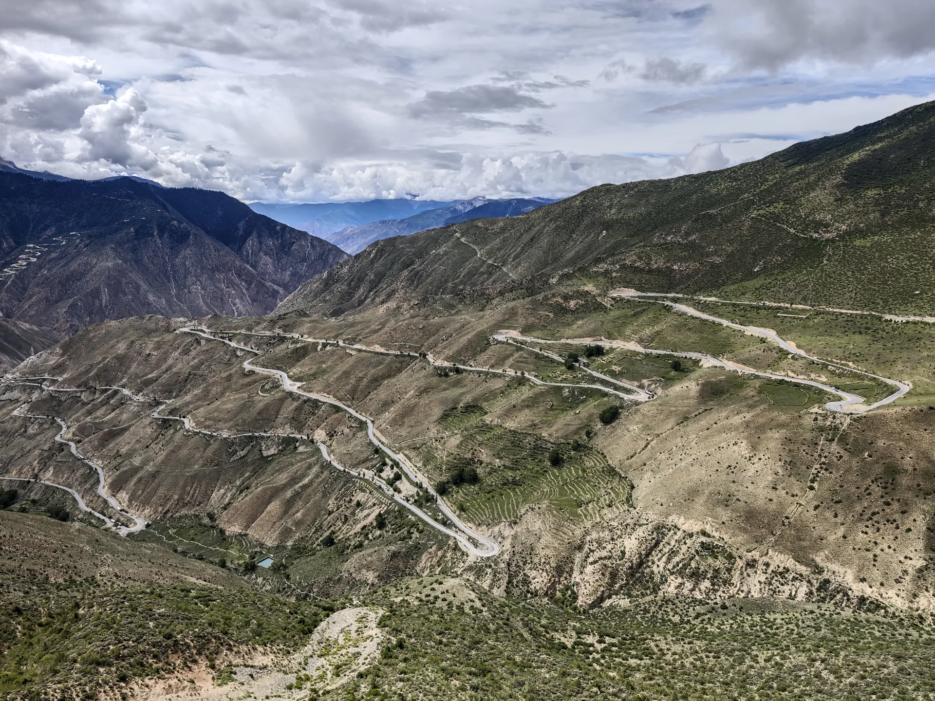 A mountain road winding across a highland hillside